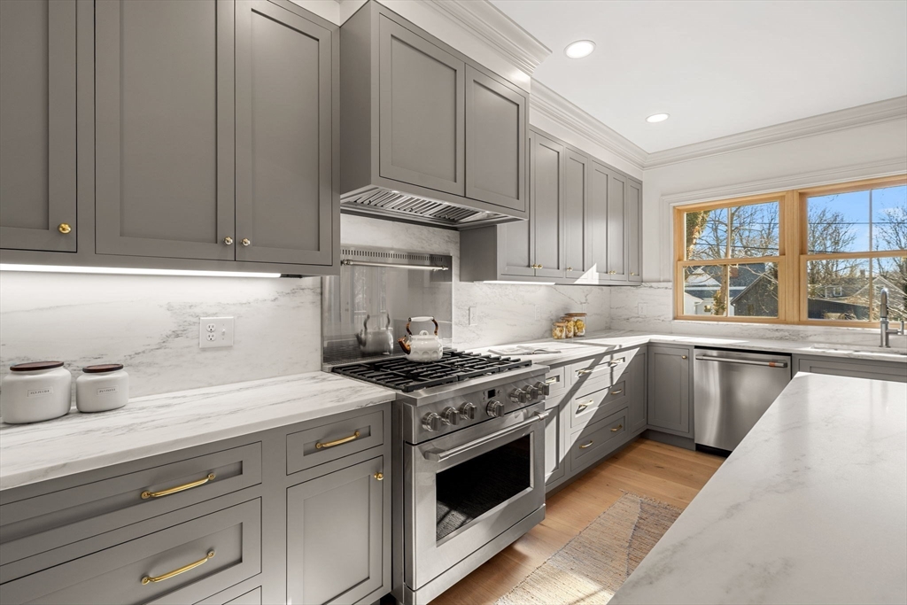 7 Flatley Avenue Manchester, MA 01944 - Photo 12 of 42 a kitchen with stainless steel appliances granite countertop a stove a sink and a refrigerator