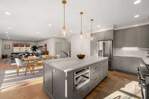 a open kitchen with stainless steel appliances granite countertop a stove and a sink
