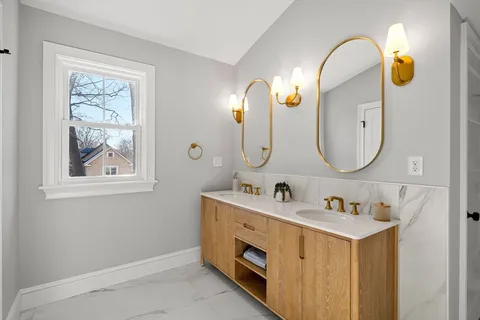a bathroom with a double vanity sink and a mirror