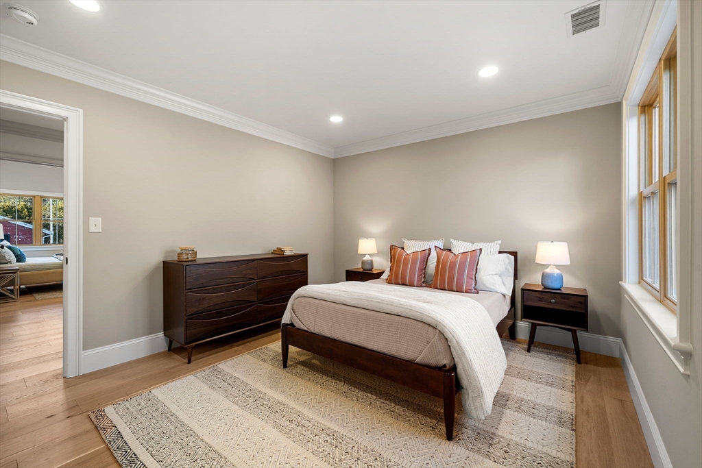 7 Flatley Avenue Manchester, MA 01944 - Photo 28 of 42 a bedroom with a bed and a dresser with mirror