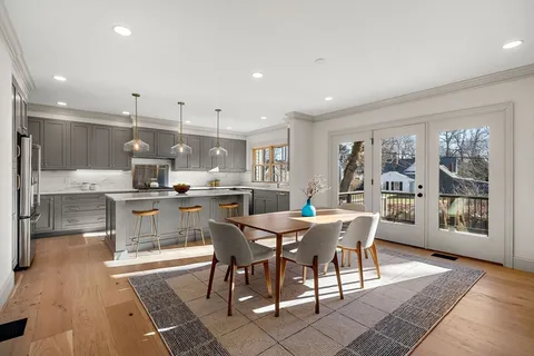 a large kitchen with a table and chairs