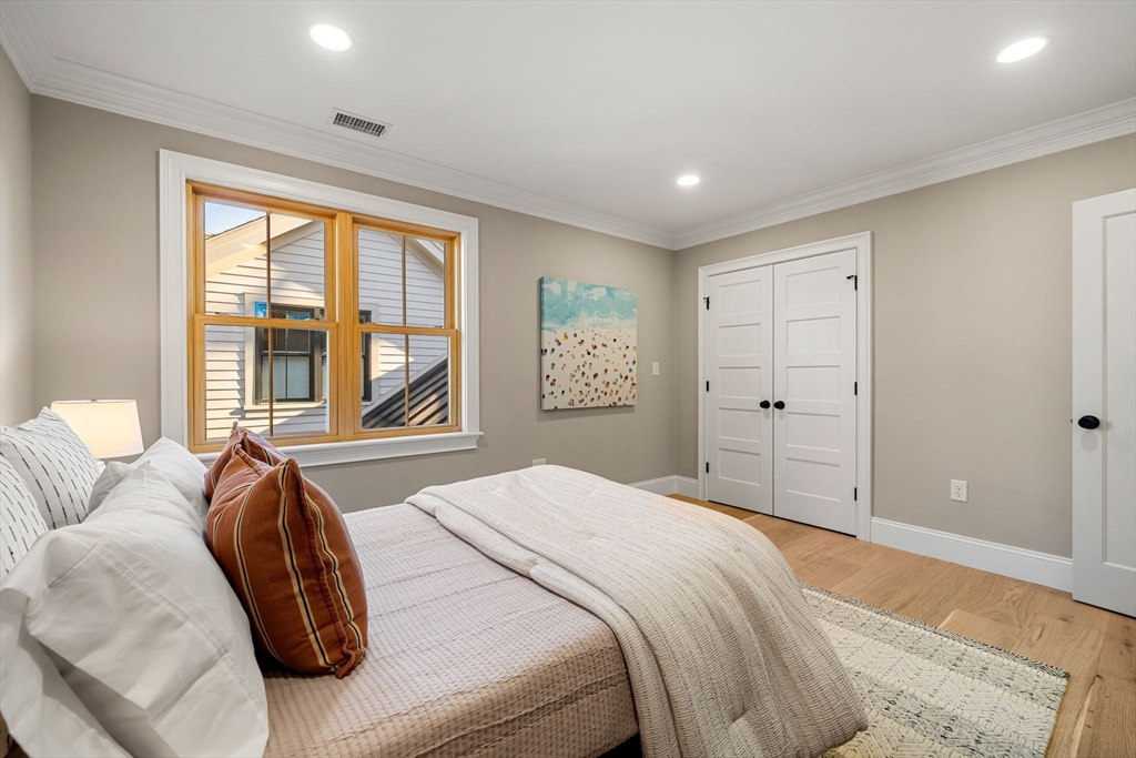 7 Flatley Avenue Manchester, MA 01944 - Photo 31 of 42 a spacious bedroom with a large bed and a large window