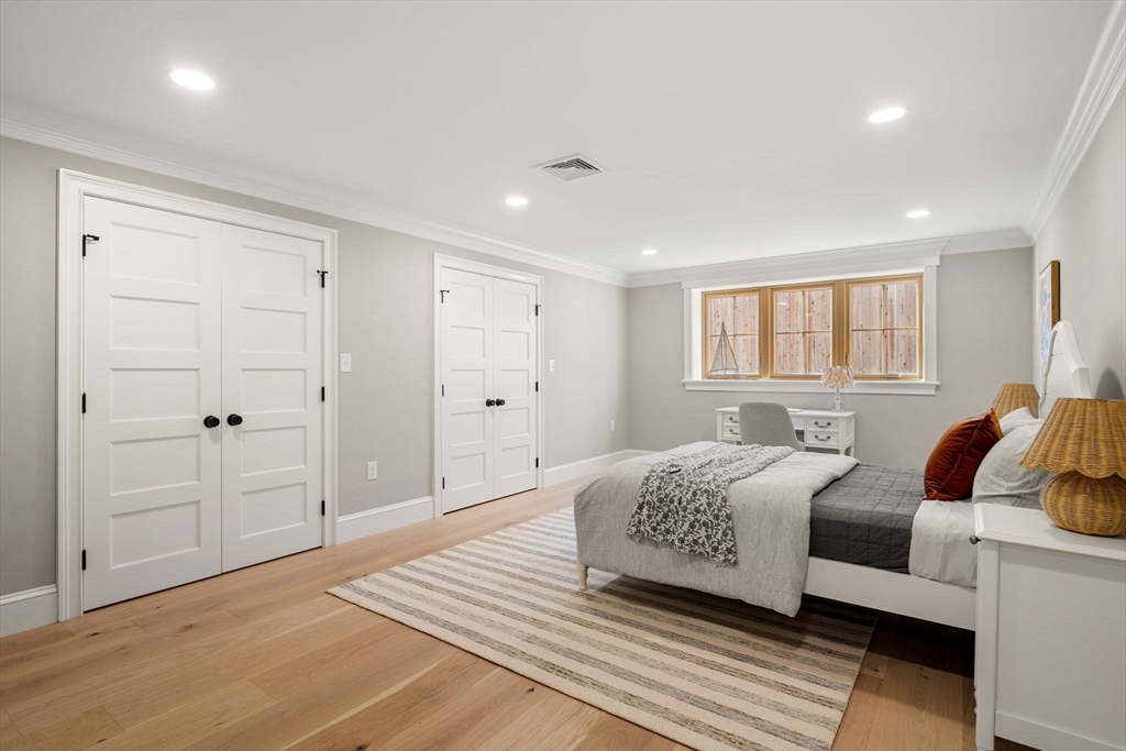 7 Flatley Avenue Manchester, MA 01944 - Photo 37 of 42 a bedroom with a large bed a rug and a window