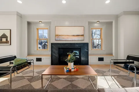 a living room with furniture a fireplace and window