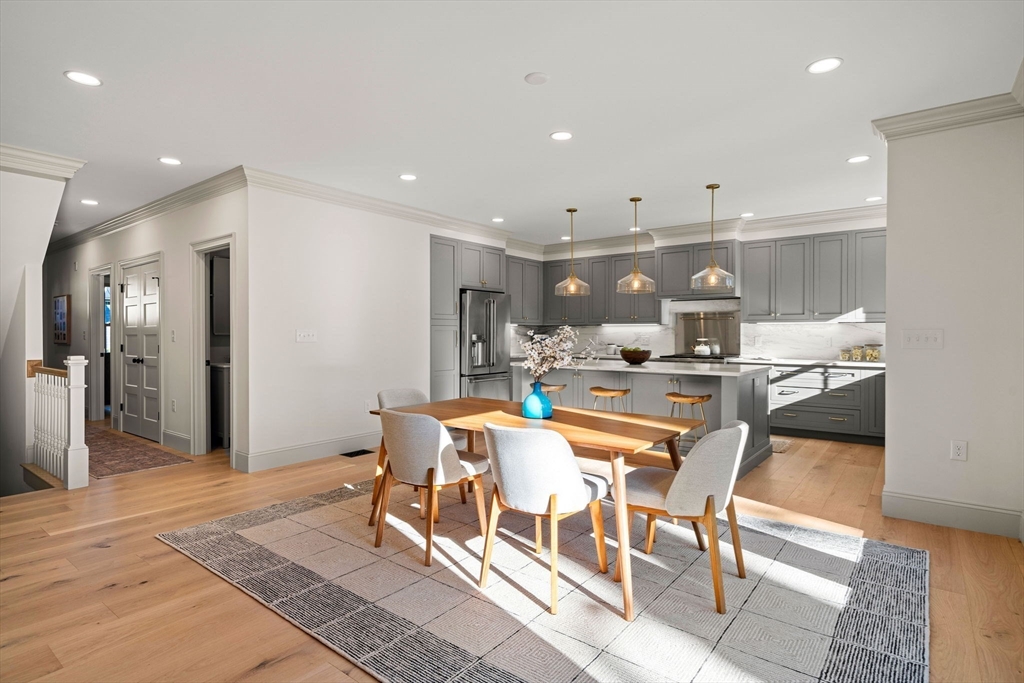 7 Flatley Avenue Manchester, MA 01944 - Photo 9 of 42 a dining room with stainless steel appliances kitchen island granite countertop a dining table and chairs