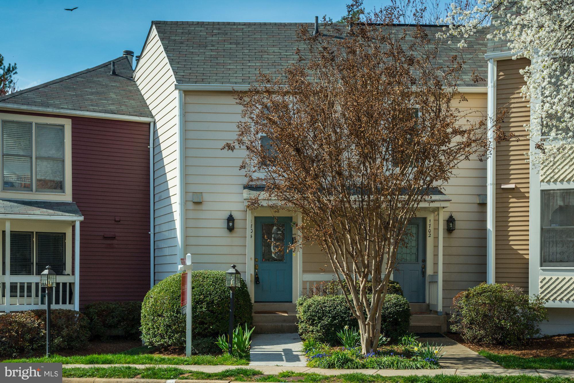 1704 Quietree Drive Reston, VA 20194 - Photo 1 of 23 a front view of a house with garden