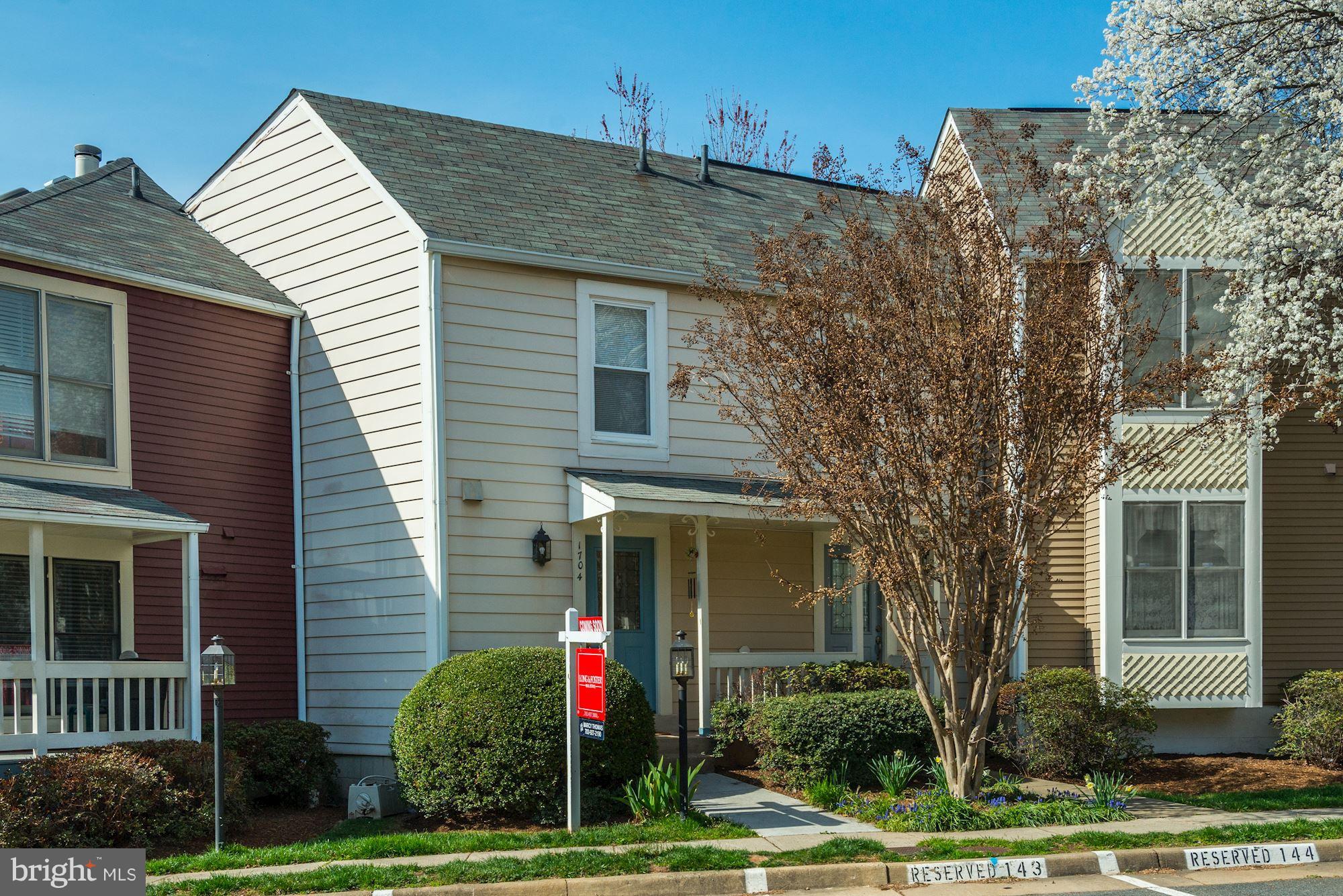 1704 Quietree Drive Reston, VA 20194 - Photo 2 of 23 a front view of a house with a yard and garage