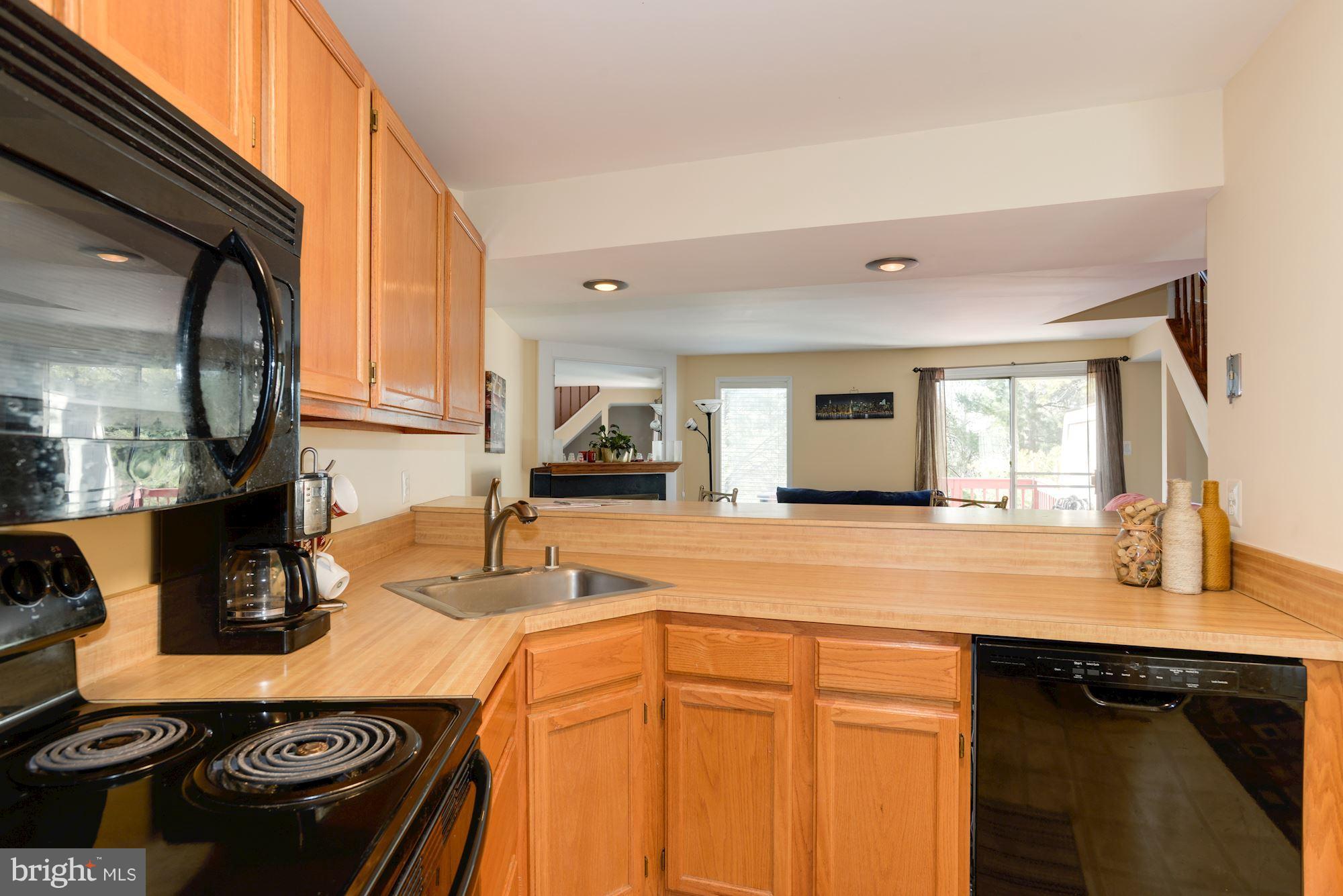 1704 Quietree Drive Reston, VA 20194 - Photo 5 of 23 a kitchen with a sink stove and cabinets