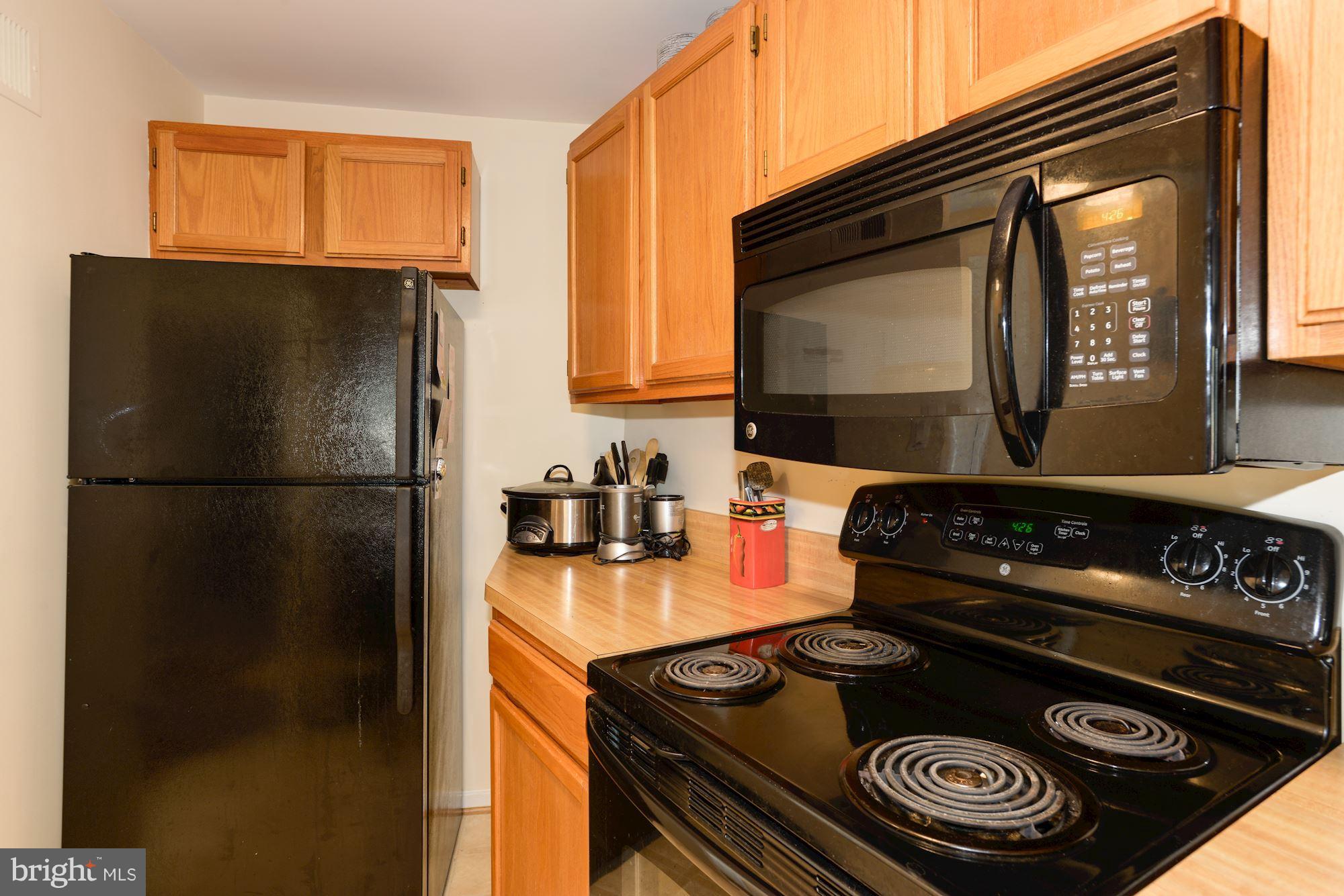 1704 Quietree Drive Reston, VA 20194 - Photo 7 of 23 a kitchen with a stove and a refrigerator