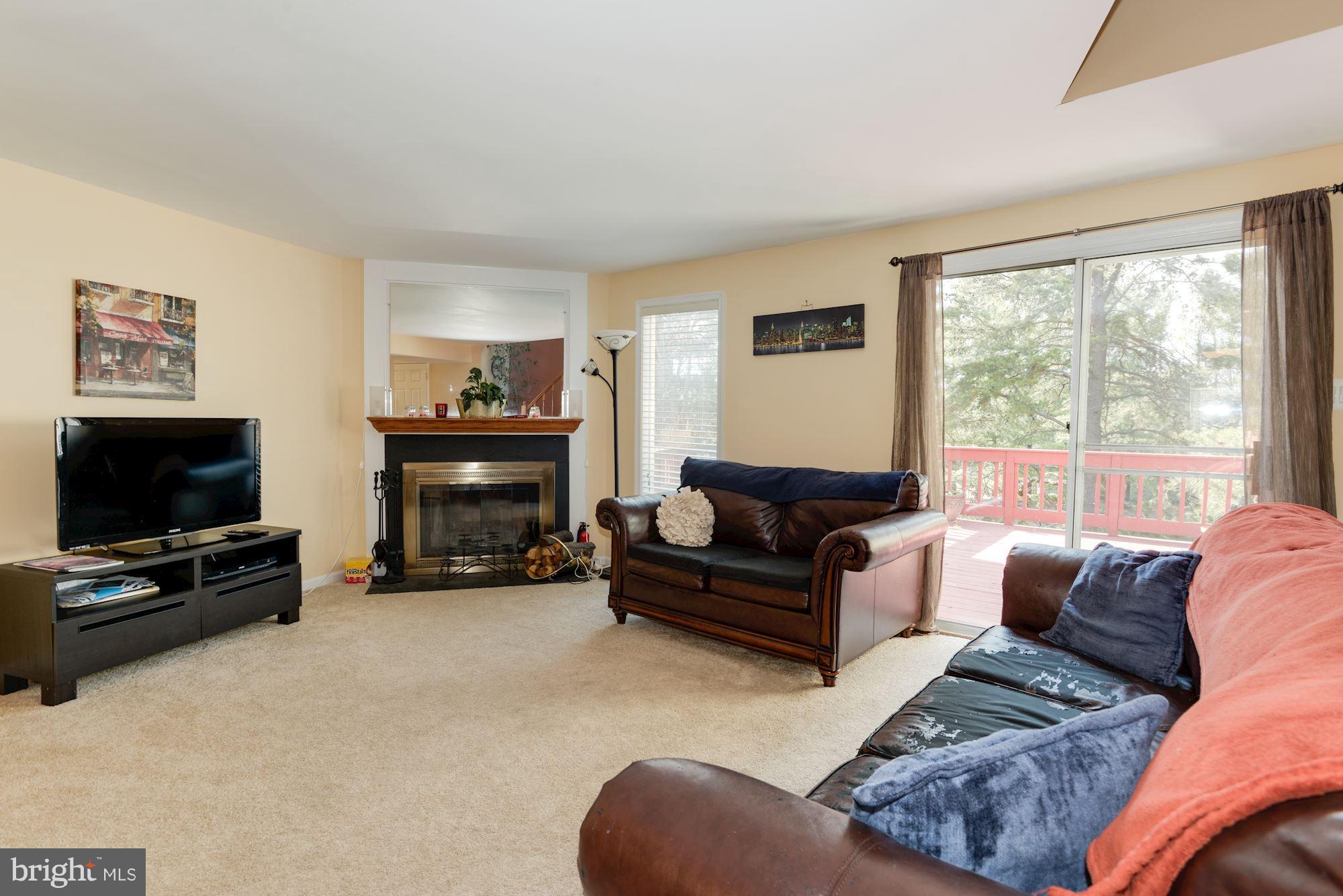 1704 Quietree Drive Reston, VA 20194 - Photo 10 of 23 a living room with furniture a flat screen tv and a fireplace