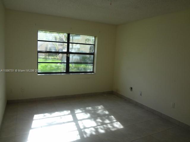 18216 Mediterranean Boulevard, Unit 119 Hialeah, FL 33015 - Photo 12 of 42 an empty room with a window