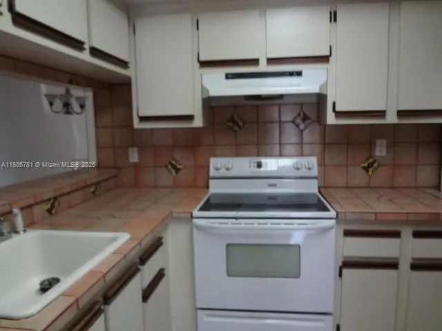 a bathroom with a shower and a sink