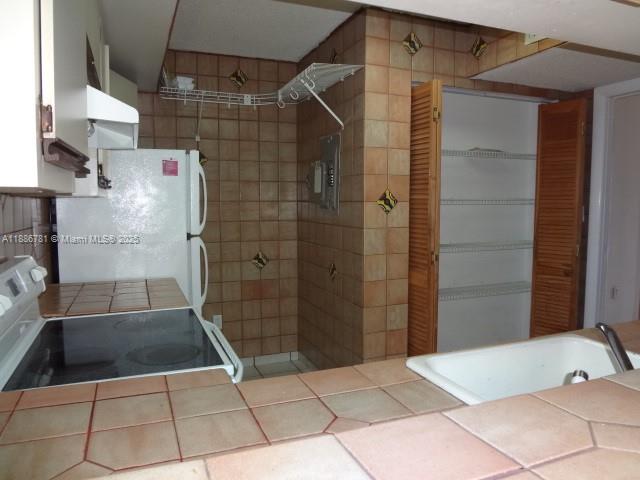 18216 Mediterranean Boulevard, Unit 119 Hialeah, FL 33015 - Photo 20 of 42 a bathroom with a shower and a sink