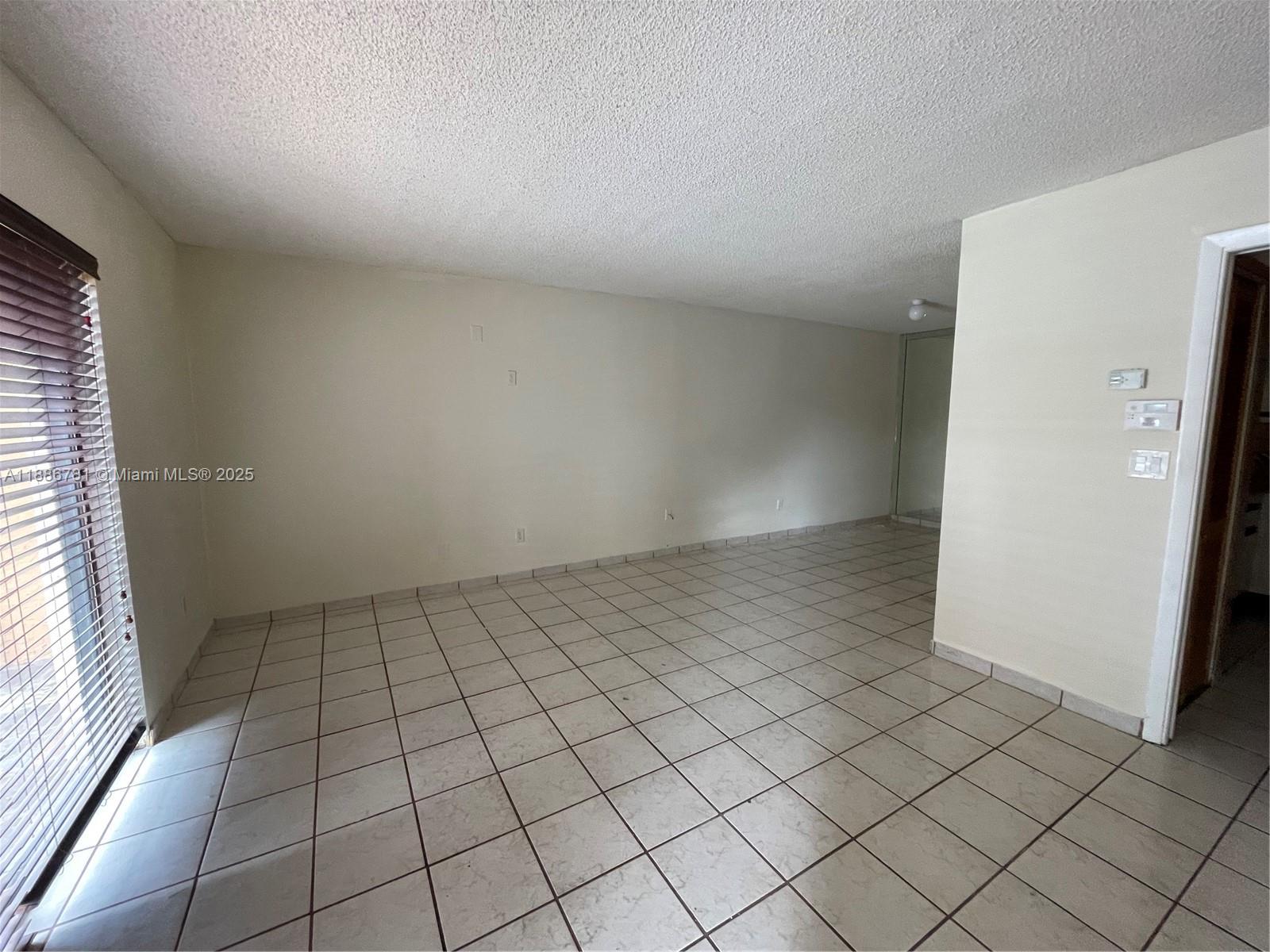 18216 Mediterranean Boulevard, Unit 119 Hialeah, FL 33015 - Photo 24 of 42 an empty room with windows