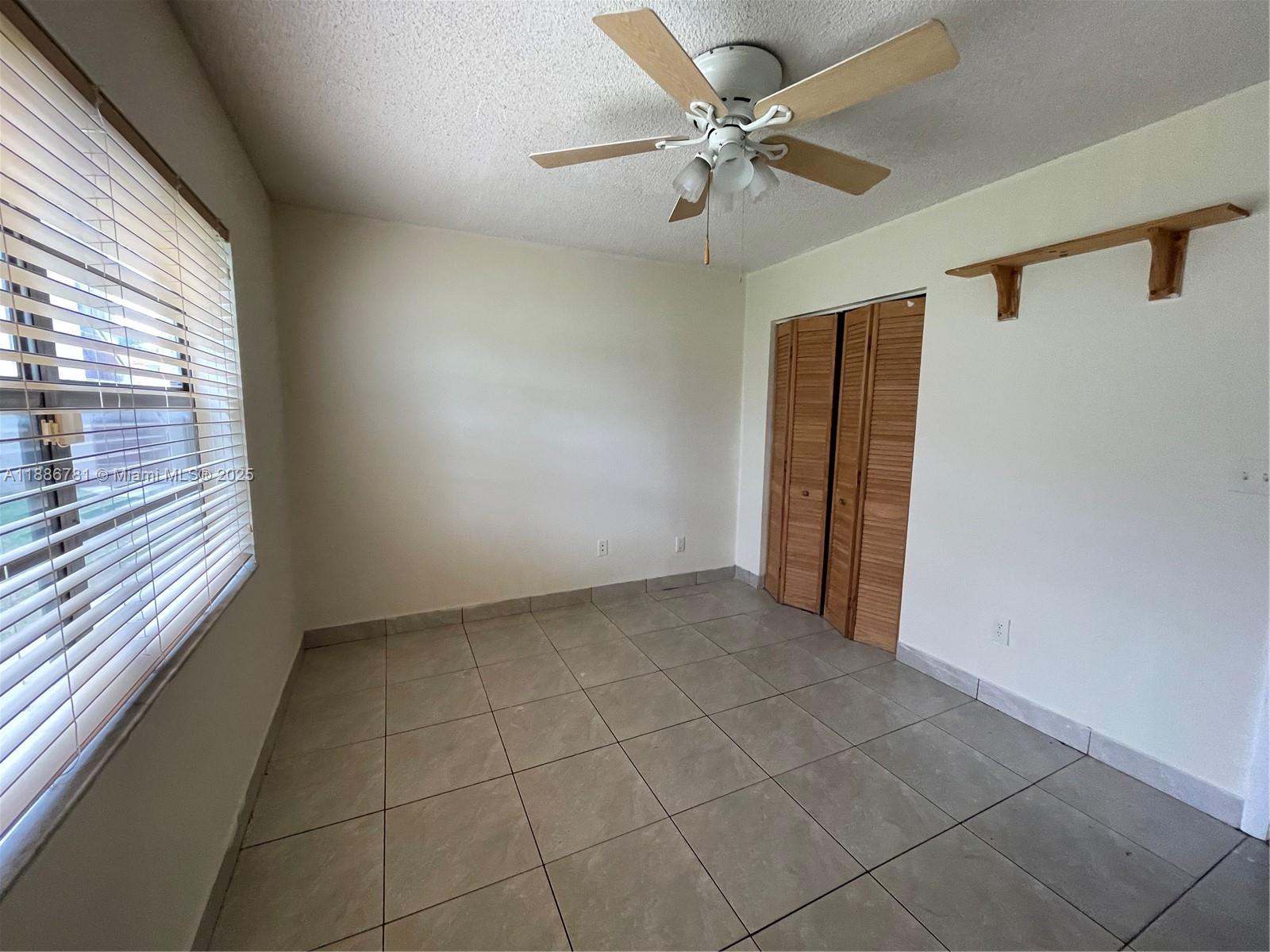 18216 Mediterranean Boulevard, Unit 119 Hialeah, FL 33015 - Photo 25 of 42 a view of an empty room with a window