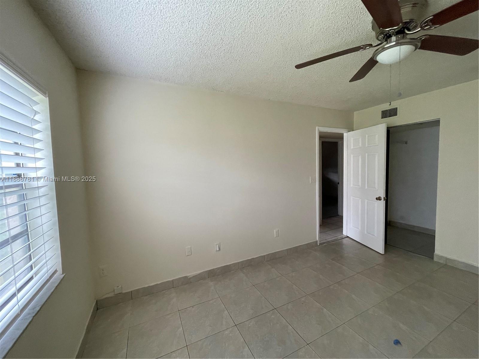 18216 Mediterranean Boulevard, Unit 119 Hialeah, FL 33015 - Photo 27 of 42 a view of an empty room with a window