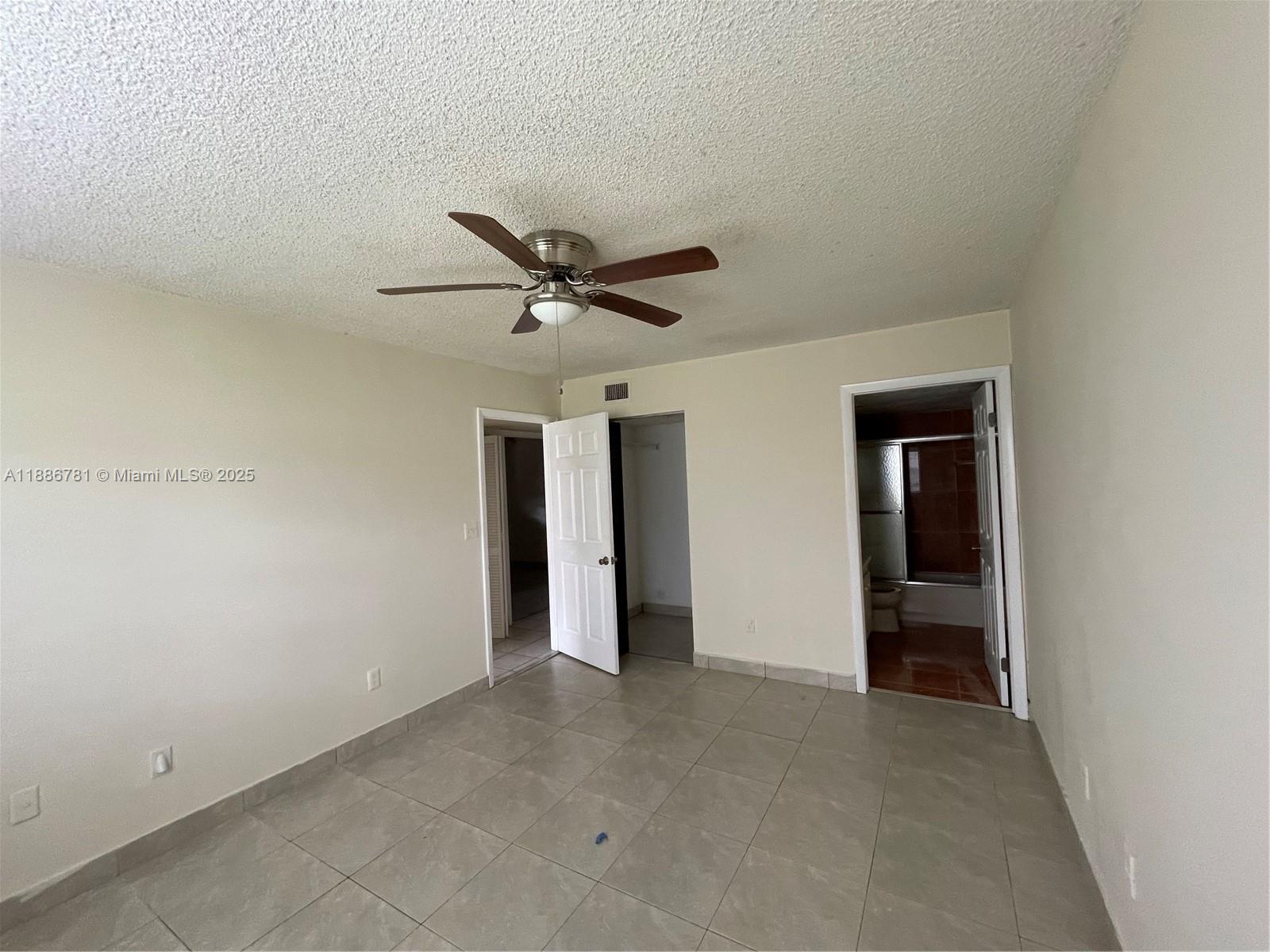 18216 Mediterranean Boulevard, Unit 119 Hialeah, FL 33015 - Photo 28 of 42 an empty room with closet and windows