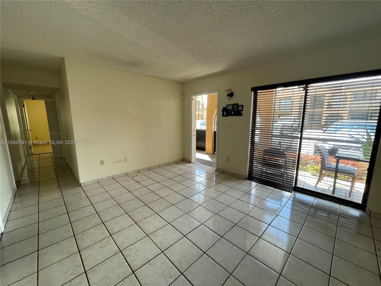 18216 Mediterranean Boulevard, Unit 119 Hialeah, FL 33015 - Photo 34 of 42 an empty room with windows