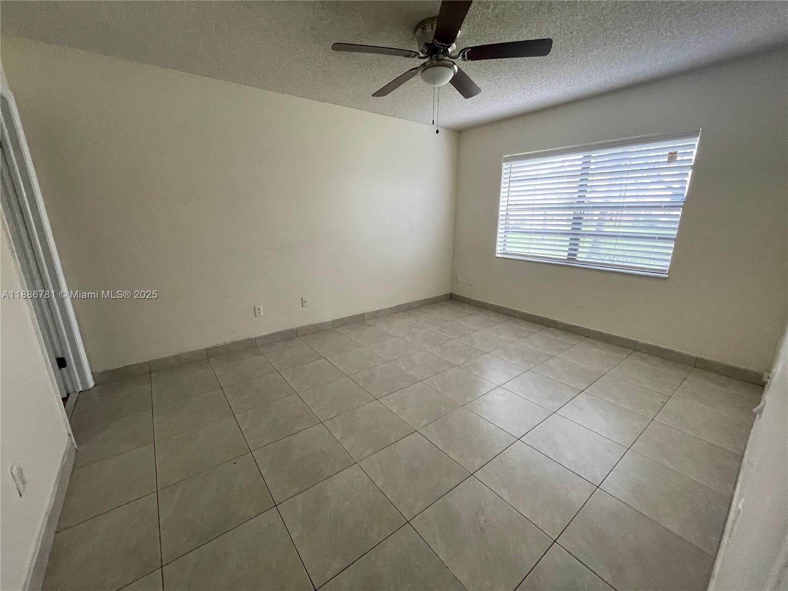 18216 Mediterranean Boulevard, Unit 119 Hialeah, FL 33015 - Photo 39 of 42 a view of an empty room with a window