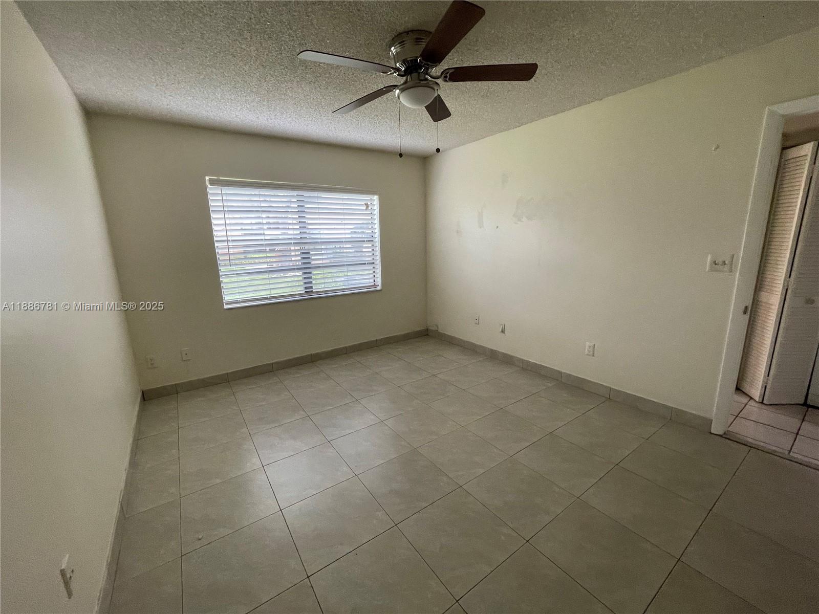 18216 Mediterranean Boulevard, Unit 119 Hialeah, FL 33015 - Photo 40 of 42 a view of an empty room with a window