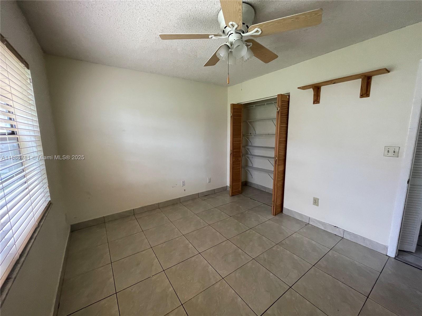 18216 Mediterranean Boulevard, Unit 119 Hialeah, FL 33015 - Photo 42 of 42 a view of an empty room with a window