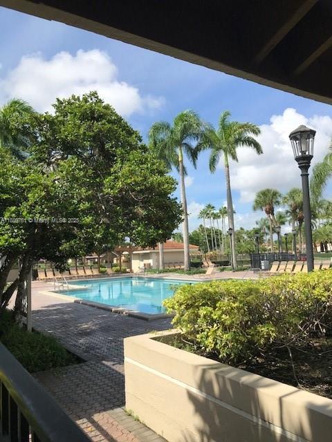 18216 Mediterranean Boulevard, Unit 119 Hialeah, FL 33015 - Photo 7 of 42 a view of a garden with a tree