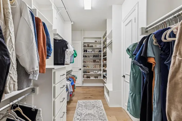a kitchen with a refrigerator sink and cabinets