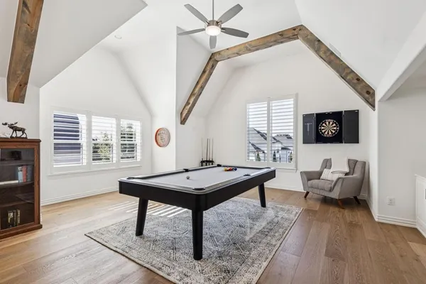a view of a dining room with furniture a fireplace and chandelier