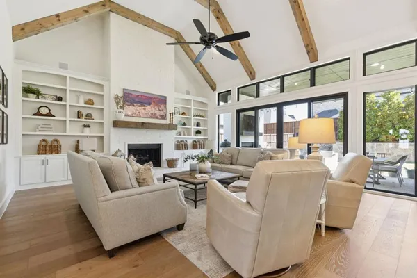 a living room with furniture wooden floor and a table