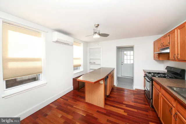 a kitchen with stainless steel appliances granite countertop a stove and a refrigerator