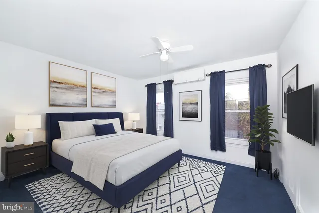 a bedroom with a large bed and a flat tv screen