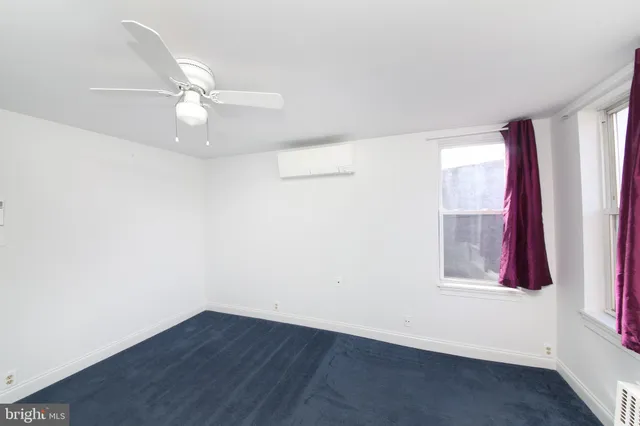 a view of a patio with table and chairs with wooden fence