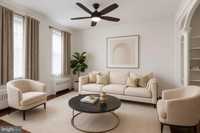 a living room with furniture a rug potted plant and a window