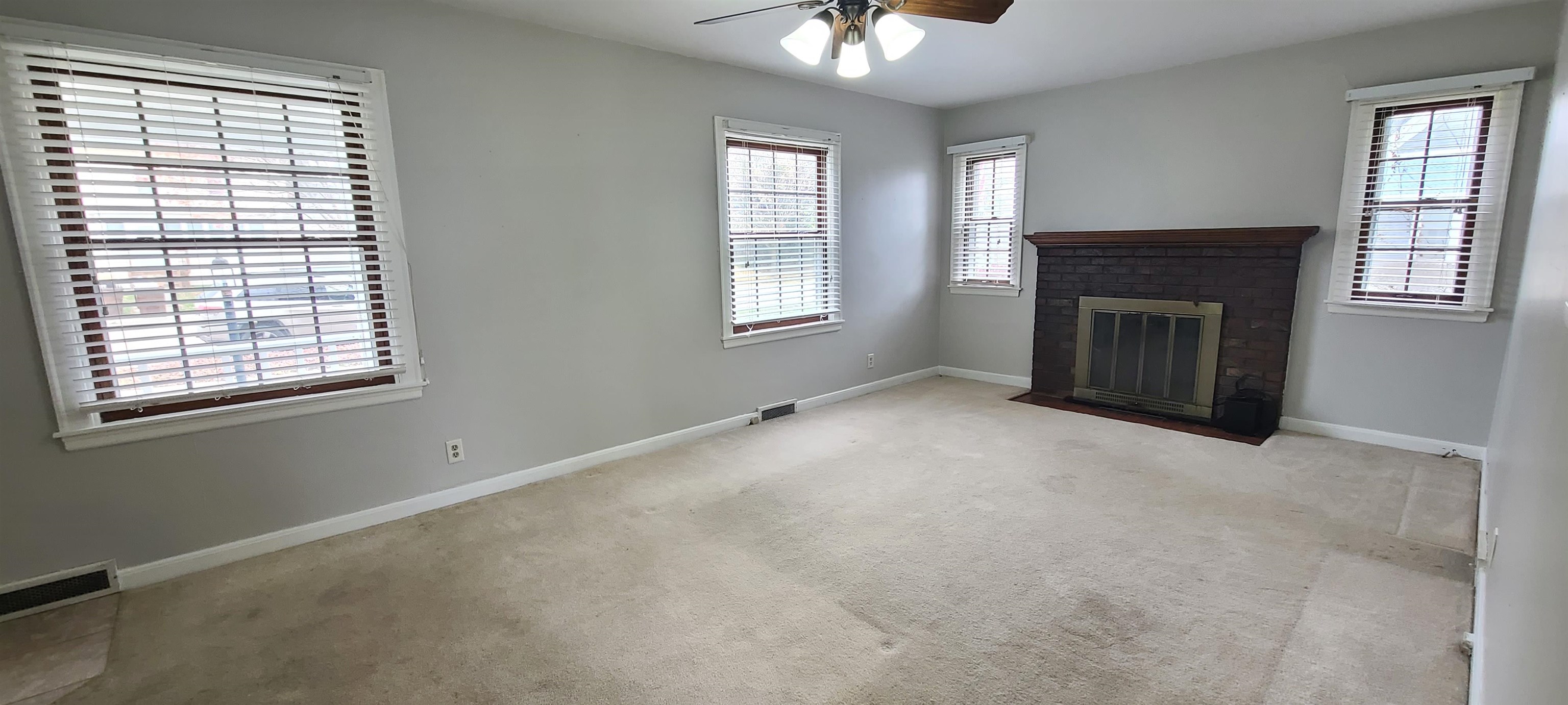 312 North 12th Street Rochelle, IL 61068 - Photo 5 of 25 an empty room with windows and fireplace