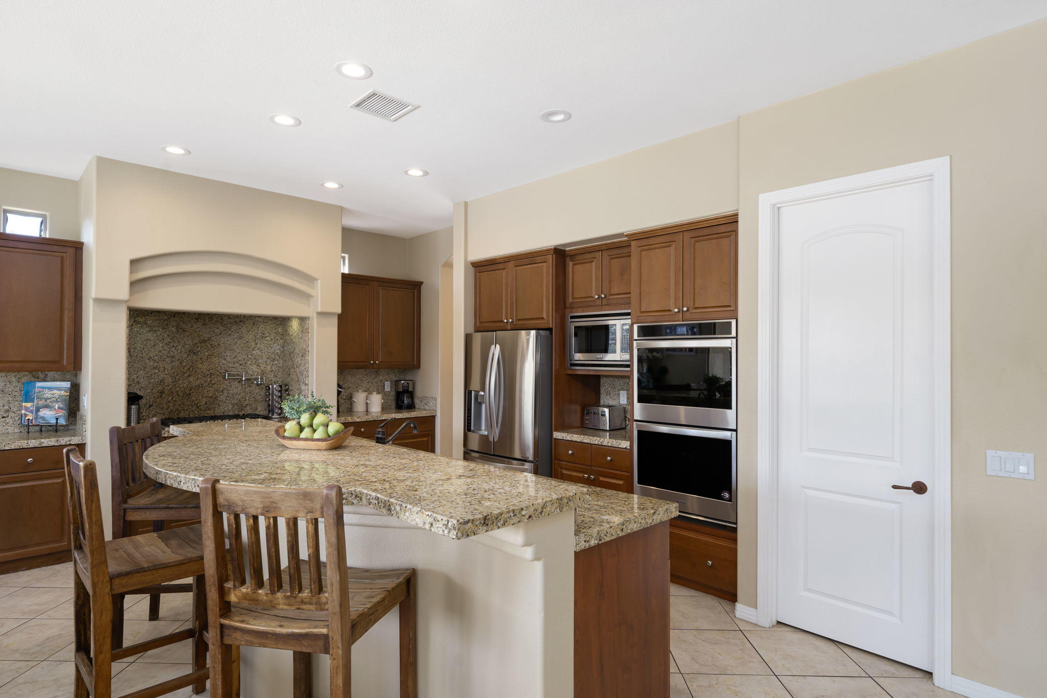 48640 Cascade Street Indio, CA 92201 - Photo 25 of 49 a kitchen with kitchen island a stove a sink and a refrigerator