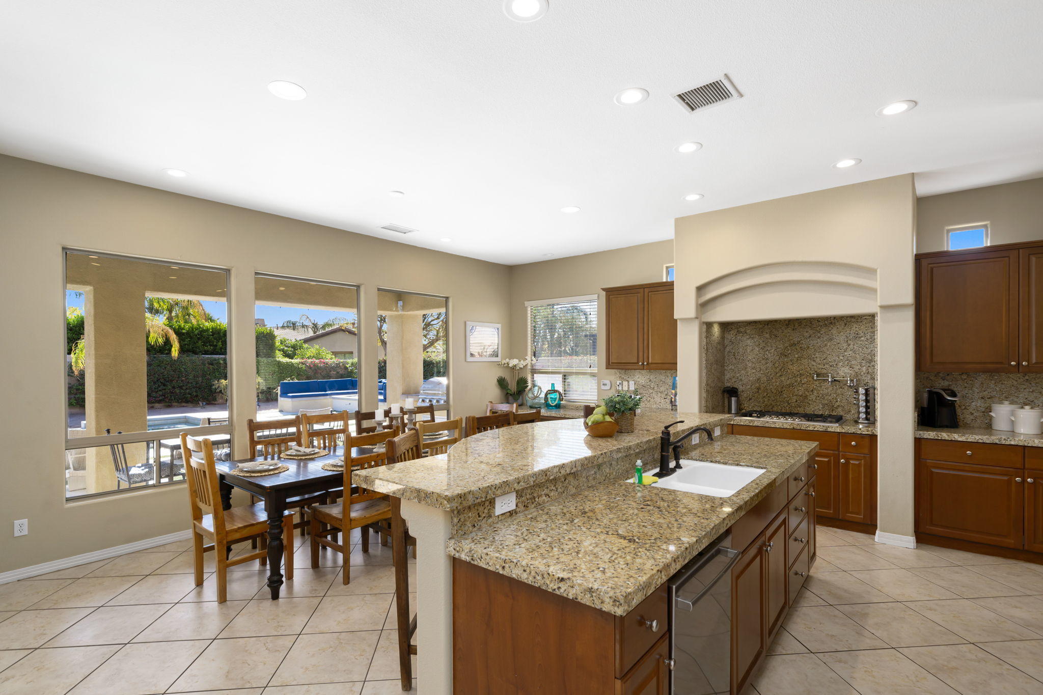 48640 Cascade Street Indio, CA 92201 - Photo 26 of 49 a kitchen with granite countertop a sink and chairs
