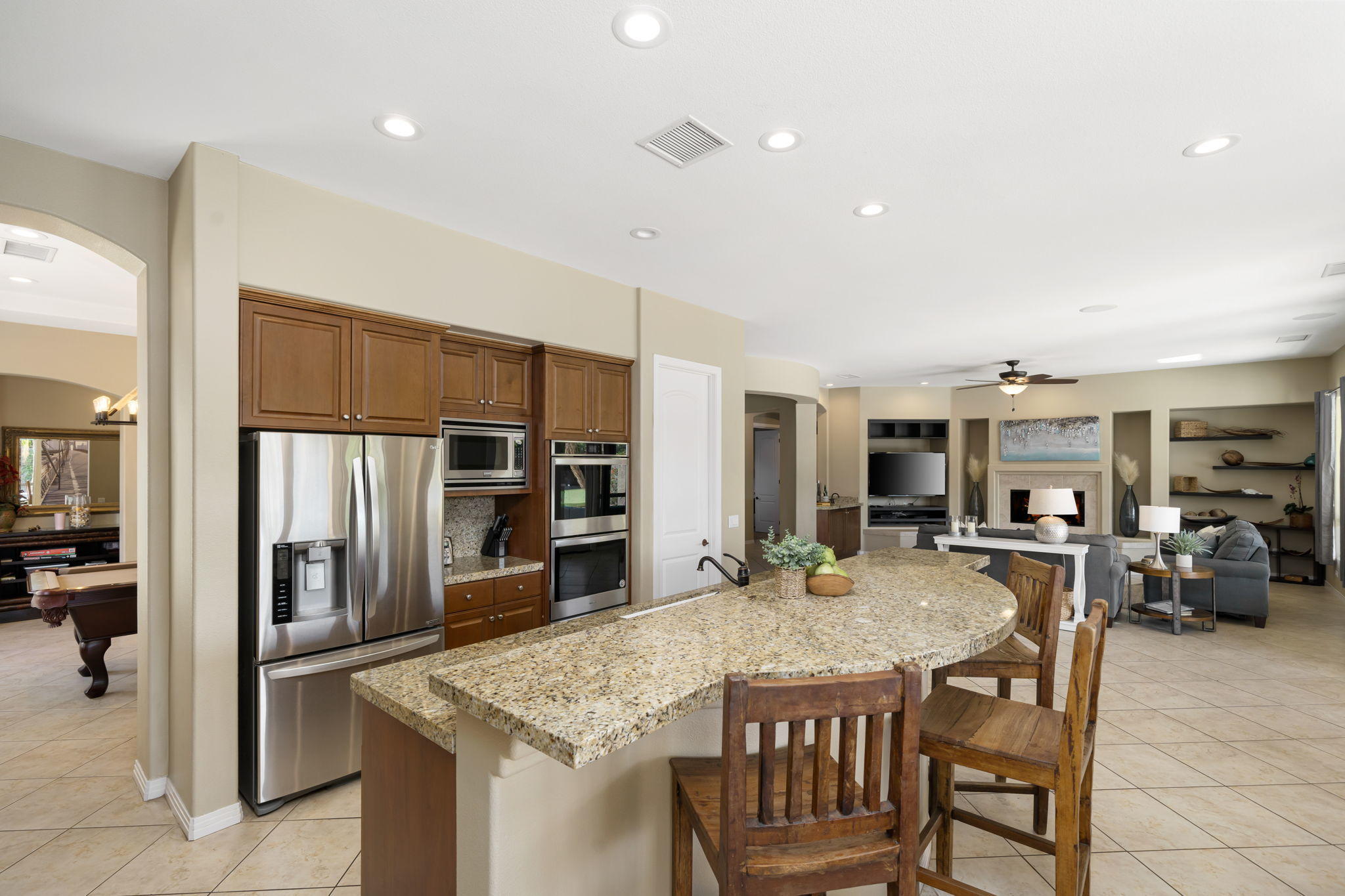 48640 Cascade Street Indio, CA 92201 - Photo 28 of 49 a kitchen with stainless steel appliances granite countertop a kitchen island a stove a refrigerator a oven a sink counter space and chairs