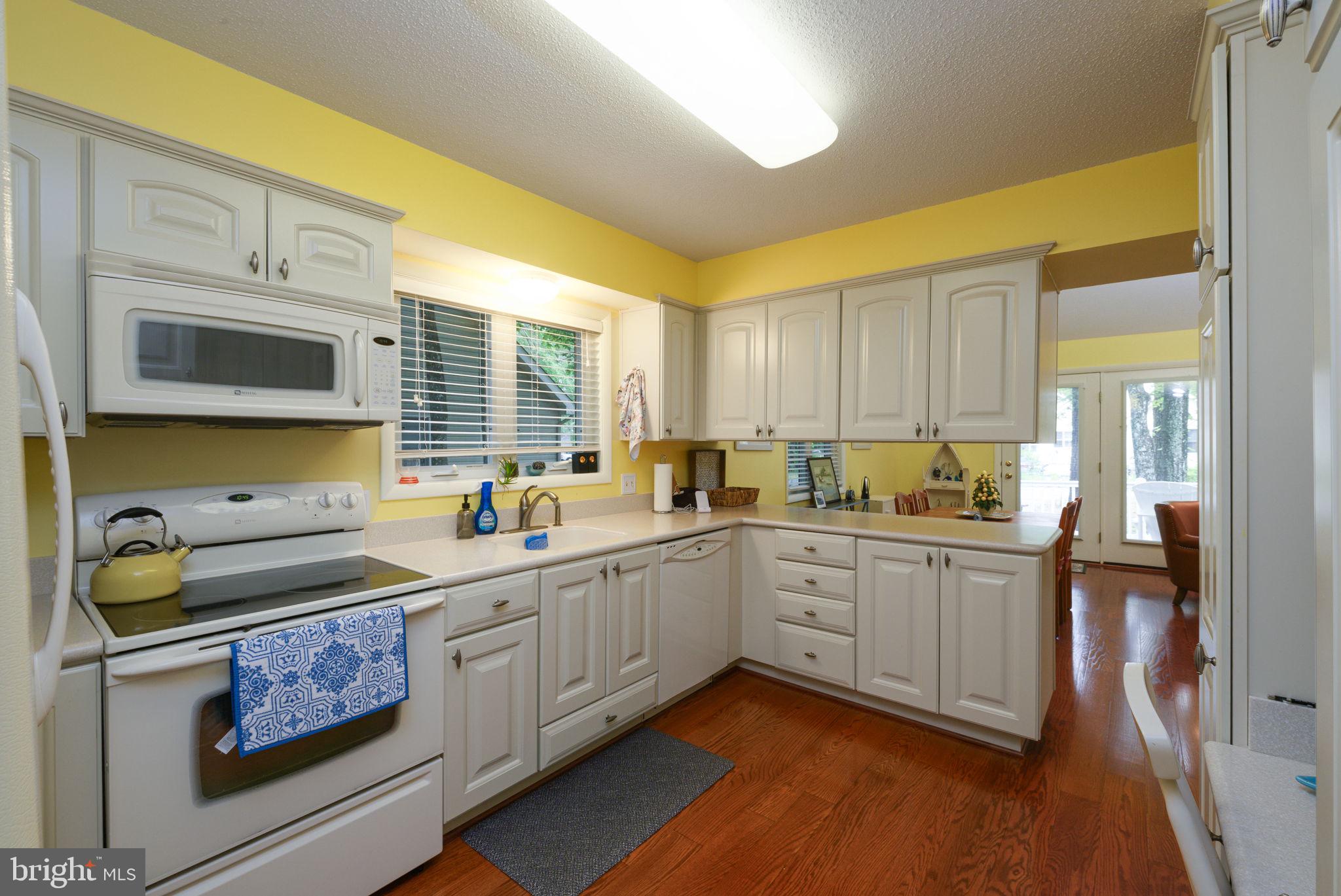 10 Gloucester Road Ocean Pines, MD 21811 - Photo 15 of 37 a kitchen with a sink stove and cabinets