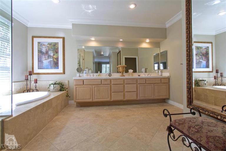 11210 Bentcreek Road Moorpark, CA 93021 - Photo 15 of 22 a bathroom with a double vanity sink a mirror and a bathtub