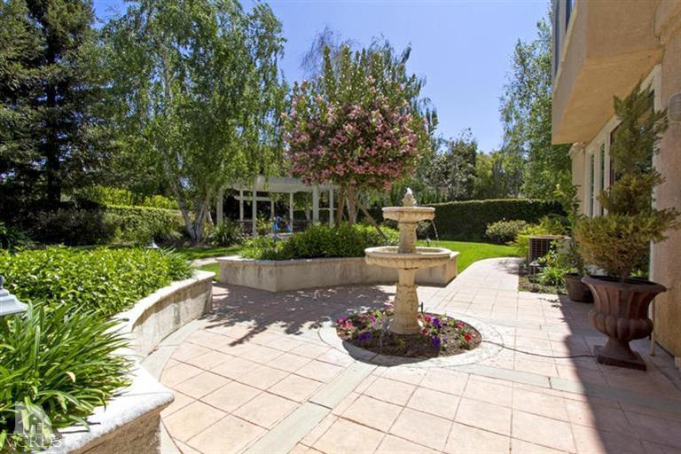 11210 Bentcreek Road Moorpark, CA 93021 - Photo 19 of 22 a view of a fountain with flower plants in front of house