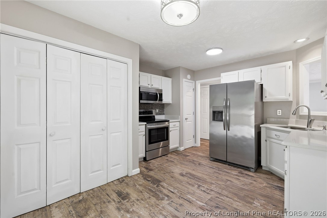 5113 Archer Road Hope Mills, NC 28348 - Photo 17 of 41 a kitchen with stainless steel appliances a refrigerator and a stove top oven