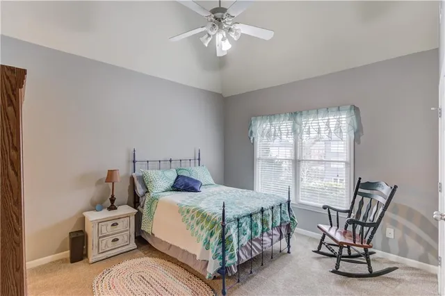 a kitchen with granite countertop white cabinets and stainless steel appliances