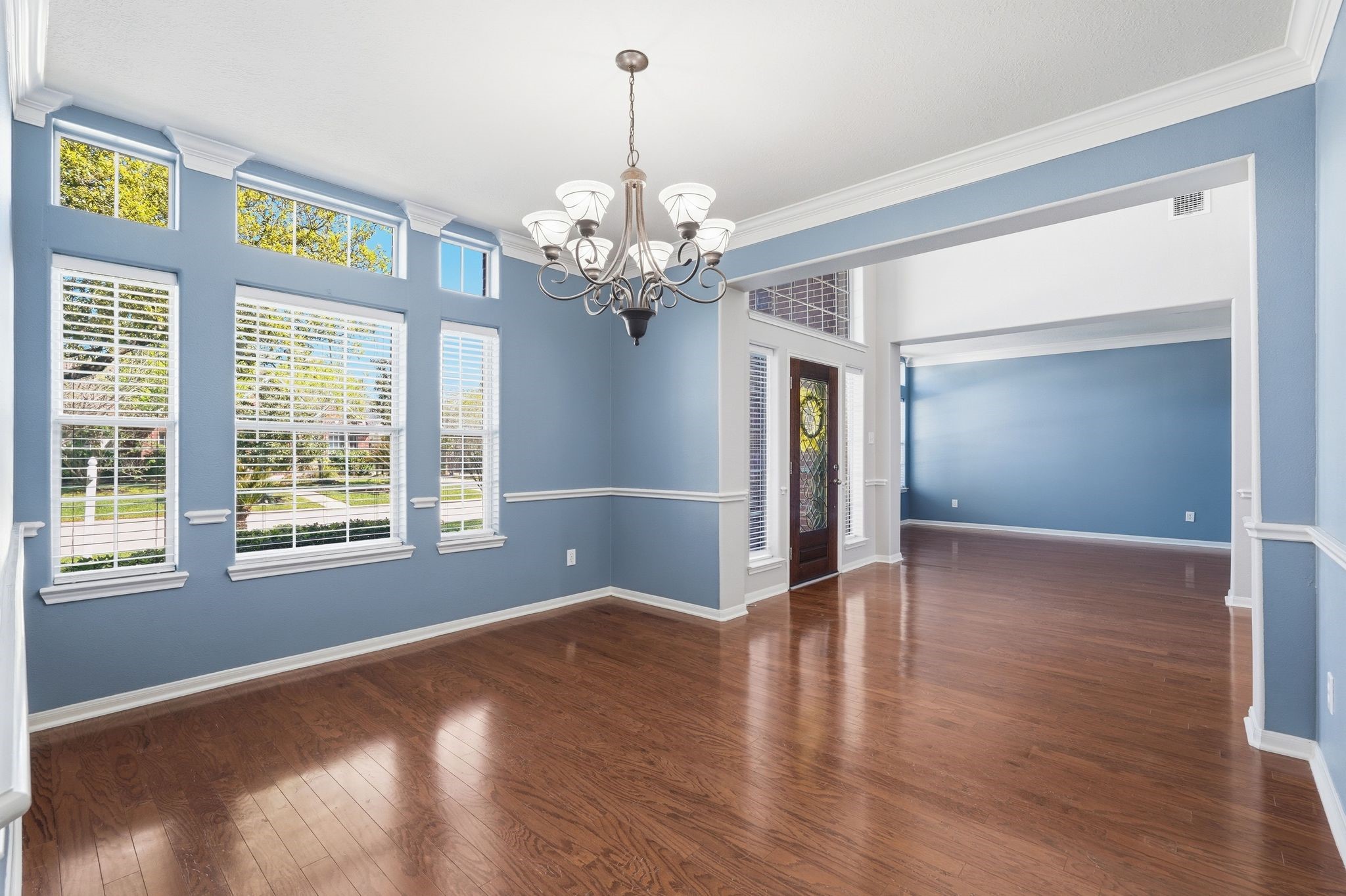 24931 Corbin Gate Drive Spring, TX 77389 - Photo 10 of 50 This spacious dining room features elegant hardwood floors with large windows that provide ample natural light. Ideal for entertaining.