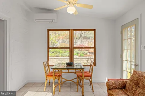 a view of patio with table and chairs and potted plants