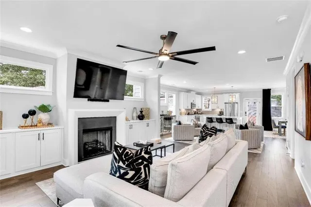 a living room with furniture a fireplace and a flat screen tv