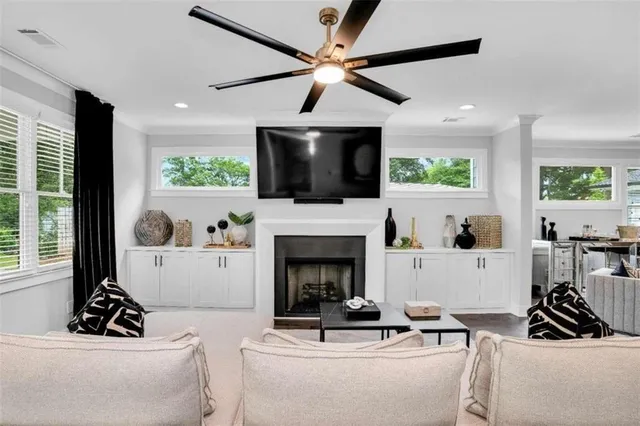 a living room with furniture a fireplace and a flat screen tv