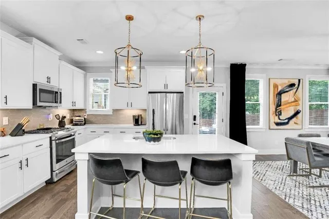 a view of kitchen with granite countertop cabinets table and chairs
