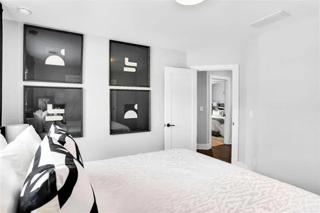 a bedroom with a bed and a mirror