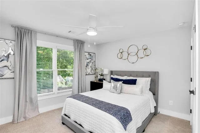 a bedroom with a large bed and a large window