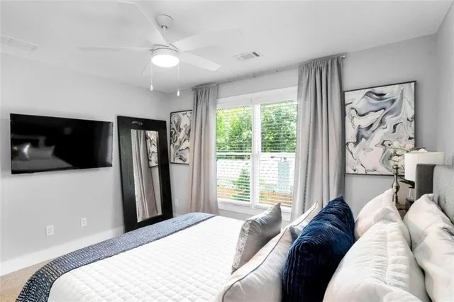 a bedroom with a large bed and a window